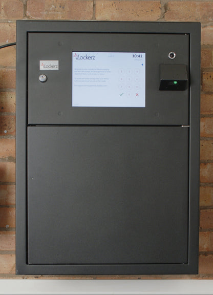 black smart safe with a touchscreen interface on a brick wall