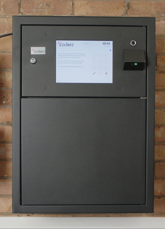 black smart safe with a touchscreen interface on a brick wall